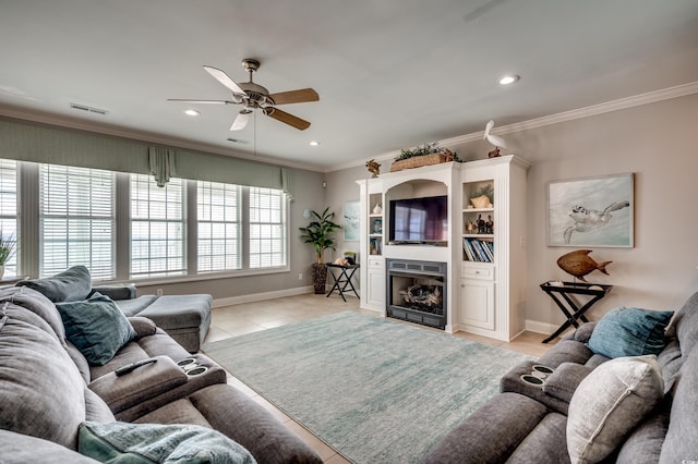 tiled living room with ceiling fan and crown molding