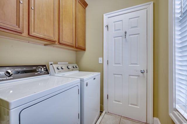 washroom featuring cabinets, light tile patterned flooring, and independent washer and dryer