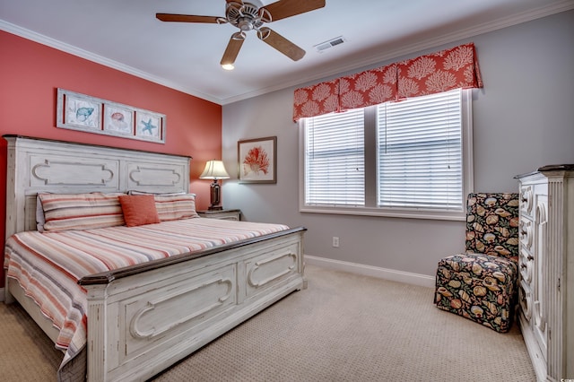 carpeted bedroom with ornamental molding and ceiling fan