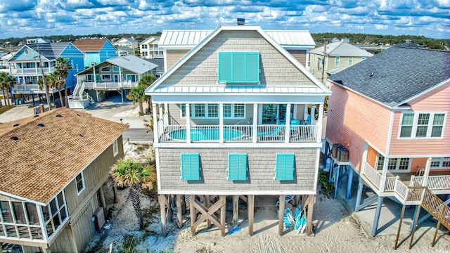 rear view of property featuring a balcony