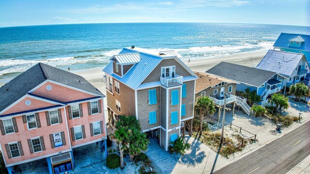 birds eye view of property with a beach view and a water view