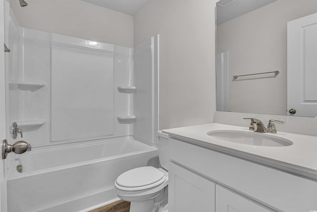 full bath with shower / bath combination, wood finished floors, toilet, and vanity