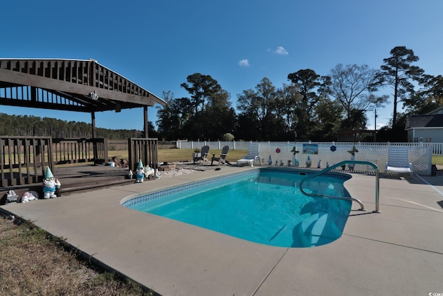 view of swimming pool with a patio area and a wooden deck