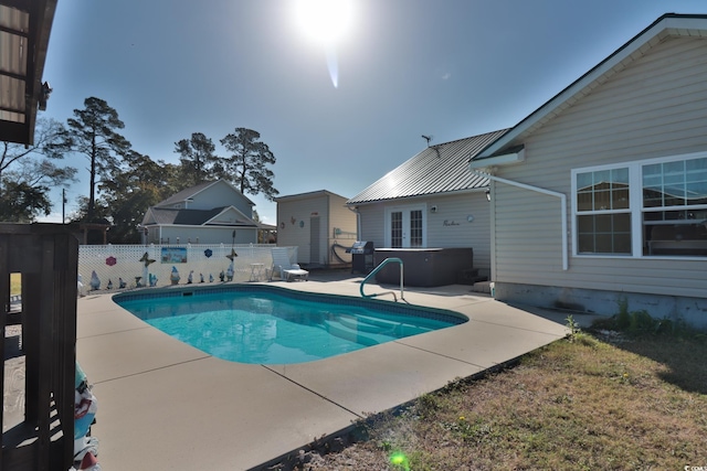 view of pool featuring area for grilling, a patio, and a hot tub