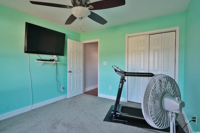 workout area with ceiling fan and carpet