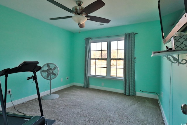 exercise area featuring carpet flooring and ceiling fan