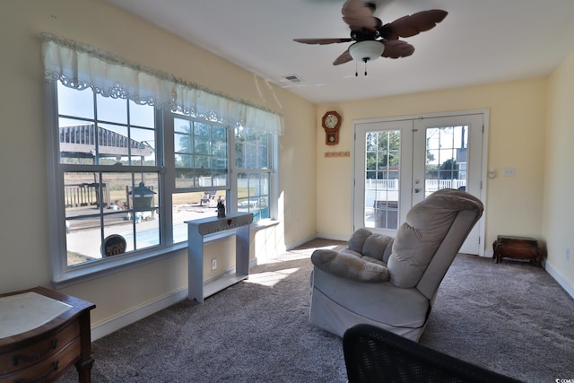 carpeted living room featuring ceiling fan and french doors