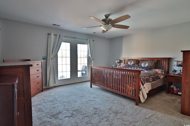 carpeted bedroom with access to outside, ceiling fan, and french doors