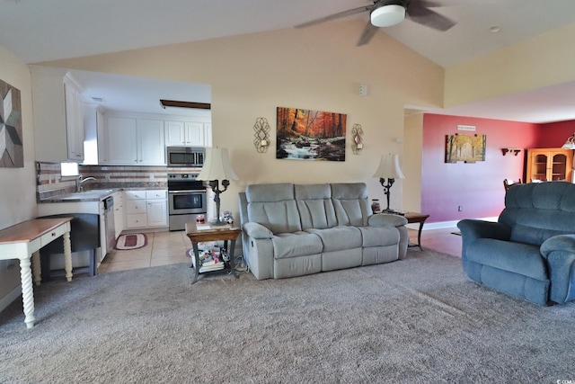 carpeted living room featuring ceiling fan, sink, and lofted ceiling