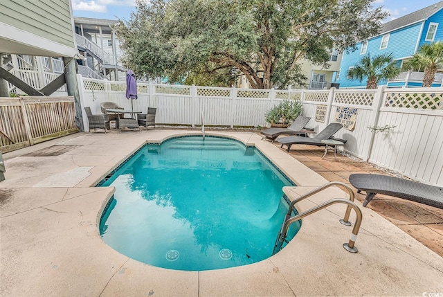 view of swimming pool with a patio area