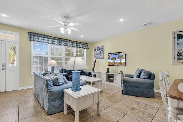 tiled living room featuring a textured ceiling and ceiling fan