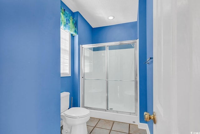 bathroom with walk in shower, tile patterned flooring, and toilet