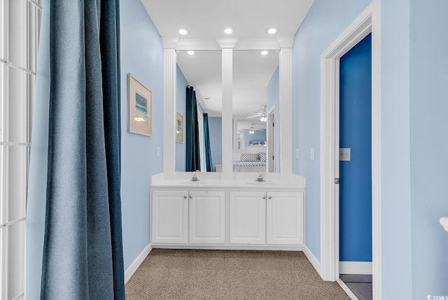 bathroom featuring ornate columns, vanity, and ceiling fan