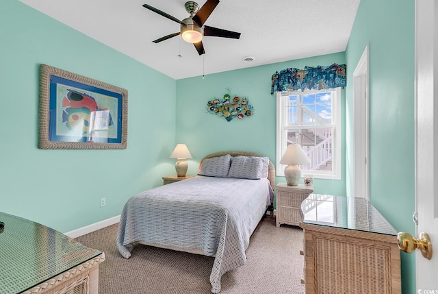 bedroom with ceiling fan and carpet flooring