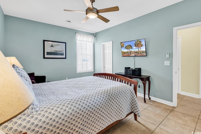 tiled bedroom featuring ceiling fan