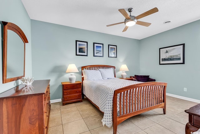 bedroom featuring light tile patterned flooring, a textured ceiling, and ceiling fan