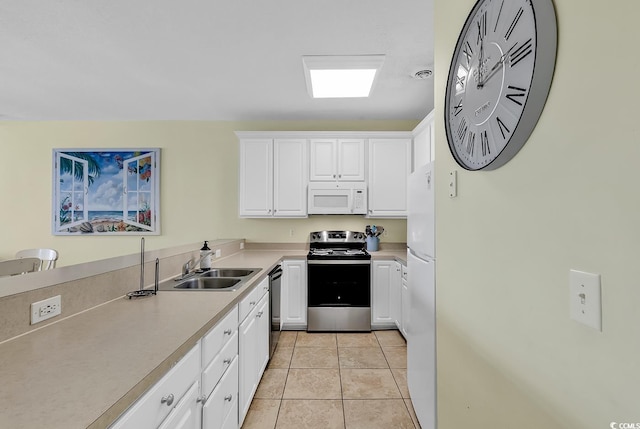 kitchen featuring light tile patterned flooring, white cabinetry, sink, and appliances with stainless steel finishes