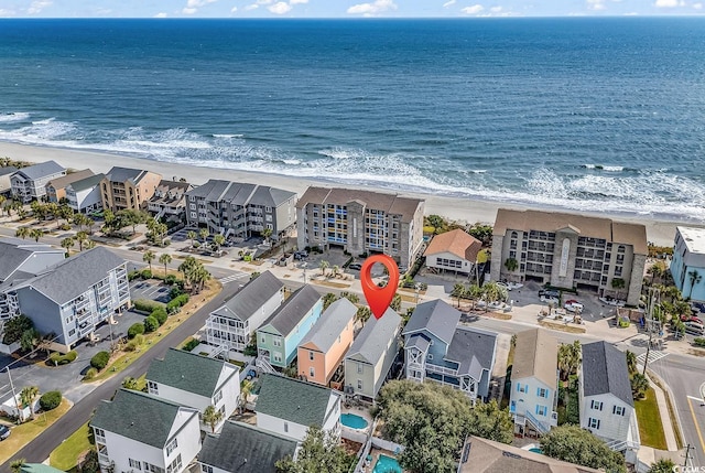 bird's eye view with a water view and a beach view