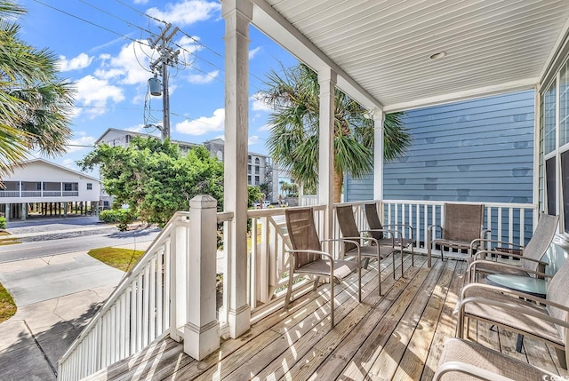 wooden terrace with a porch