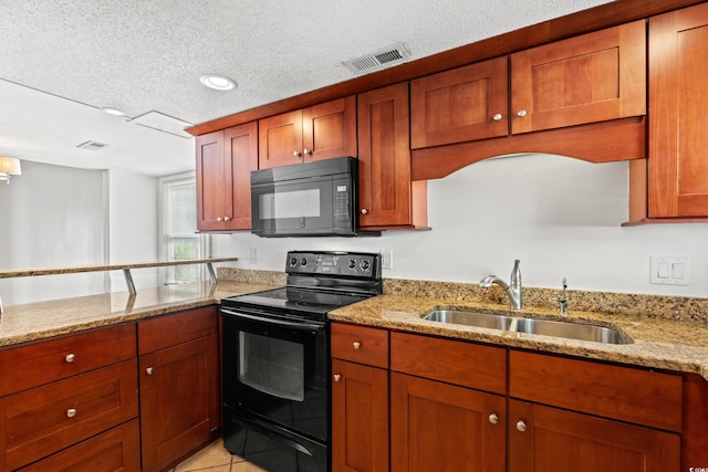 kitchen with a textured ceiling, black appliances, sink, and light stone countertops