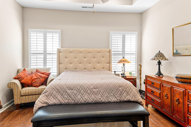 bedroom with dark hardwood / wood-style floors