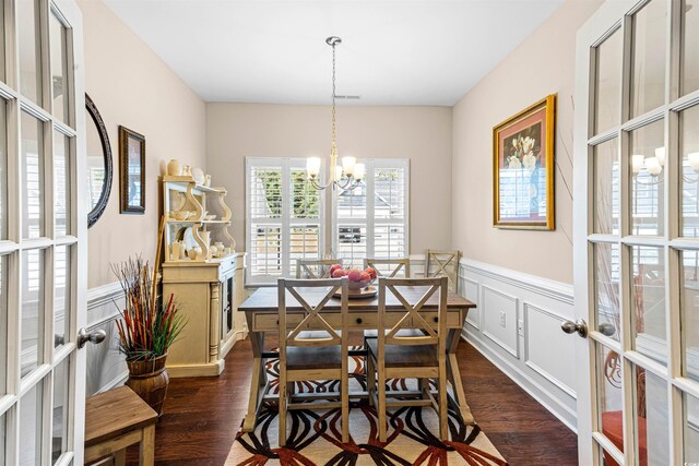 dining room featuring french doors, dark hardwood / wood-style flooring, and a notable chandelier