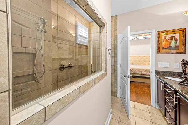 bathroom with hardwood / wood-style floors, ceiling fan, vanity, and tiled shower