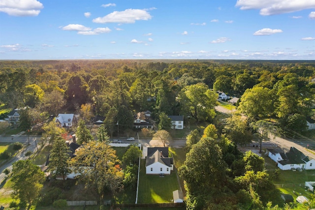 bird's eye view featuring a residential view and a wooded view