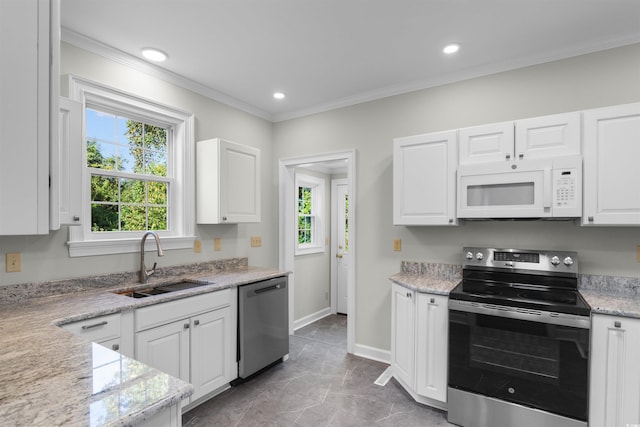 kitchen featuring stainless steel appliances, white cabinets, and a sink