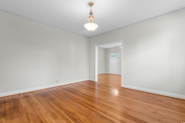 unfurnished room with baseboards and light wood-style floors