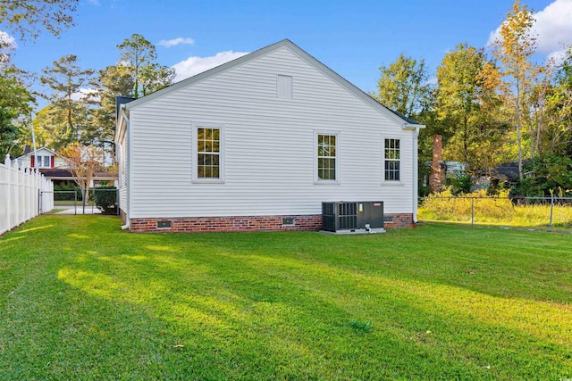 view of property exterior with crawl space, a fenced backyard, central AC, and a yard