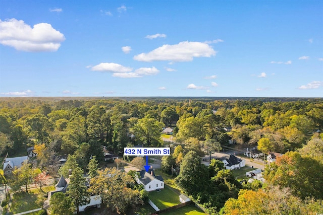 birds eye view of property featuring a wooded view