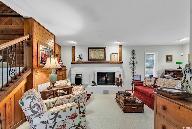 carpeted living room featuring a large fireplace