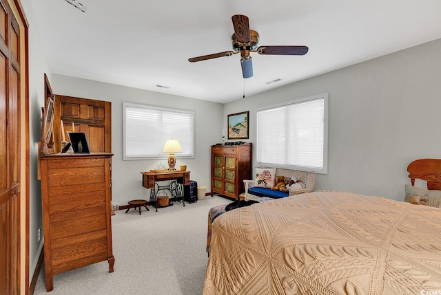 carpeted bedroom featuring ceiling fan and a closet