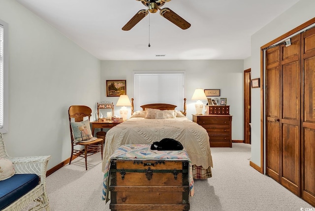 carpeted bedroom featuring ceiling fan and a closet