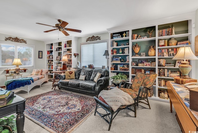 living area with light colored carpet and ceiling fan