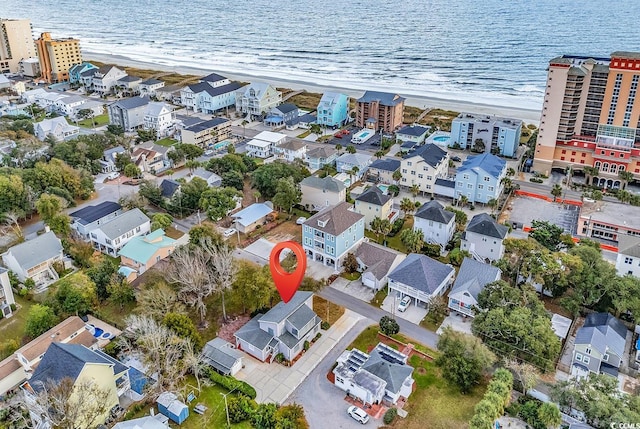 drone / aerial view featuring a view of the beach and a water view