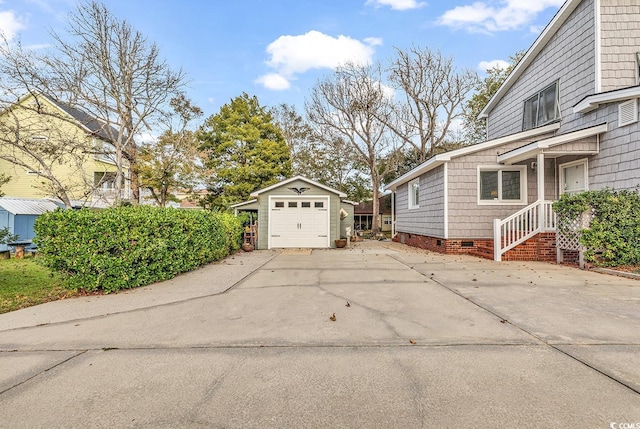 view of side of property featuring a garage and an outdoor structure