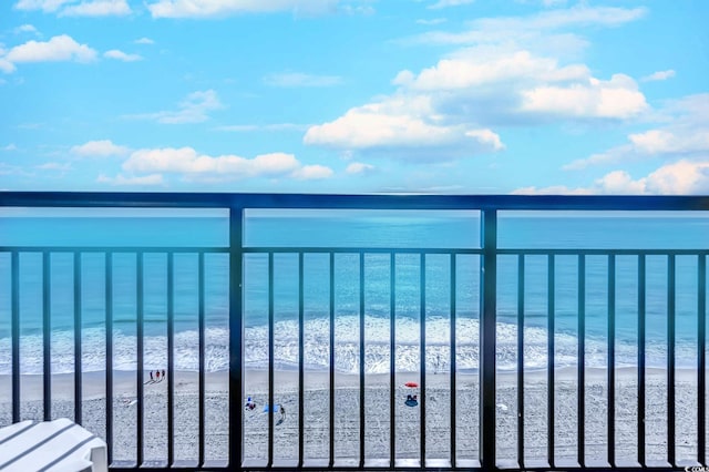 balcony featuring a beach view and a water view