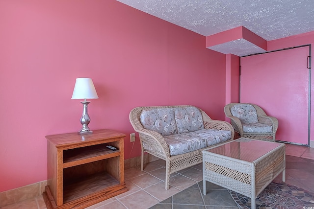 living room with tile patterned flooring and a textured ceiling