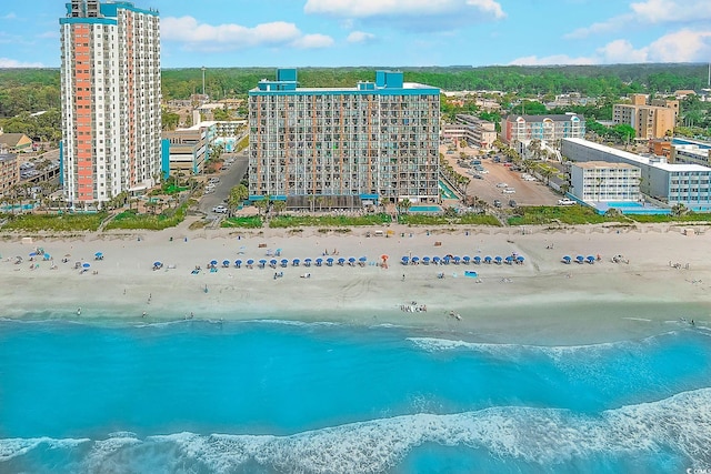 bird's eye view featuring a water view and a beach view