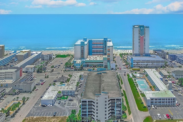 drone / aerial view featuring a beach view and a water view