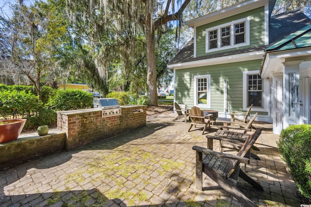 view of patio featuring exterior kitchen and area for grilling