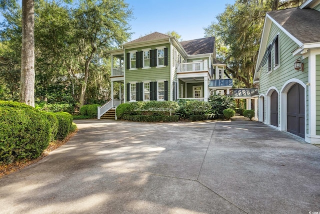 view of front of house with a garage and a balcony