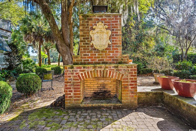 view of patio / terrace featuring an outdoor brick fireplace