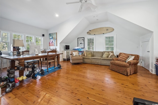 living room featuring vaulted ceiling, ceiling fan, and light hardwood / wood-style flooring