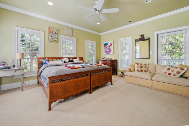 carpeted bedroom with ornamental molding and ceiling fan