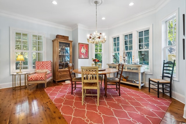 dining area featuring a chandelier, hardwood / wood-style flooring, and crown molding