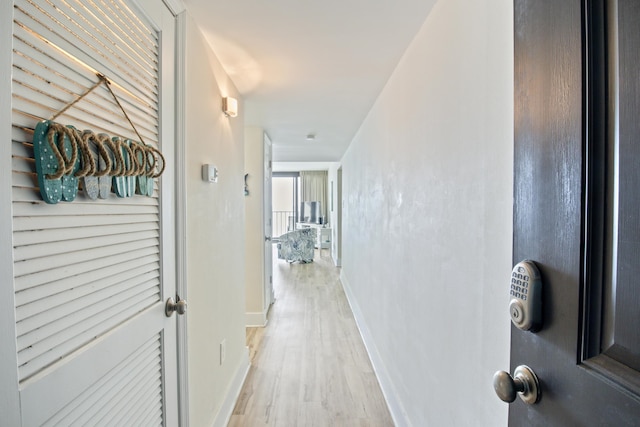 corridor with light wood-type flooring