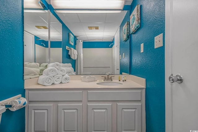 1207 S Ocean Blvd Unit 51408, Myrtle Beach, SC 29577 - bathroom featuring a textured wall, a paneled ceiling, and vanity